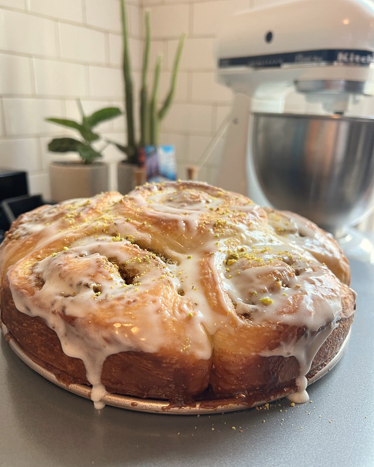 A pan of glazed pistachio sweet rolls fresh from the kitchen
